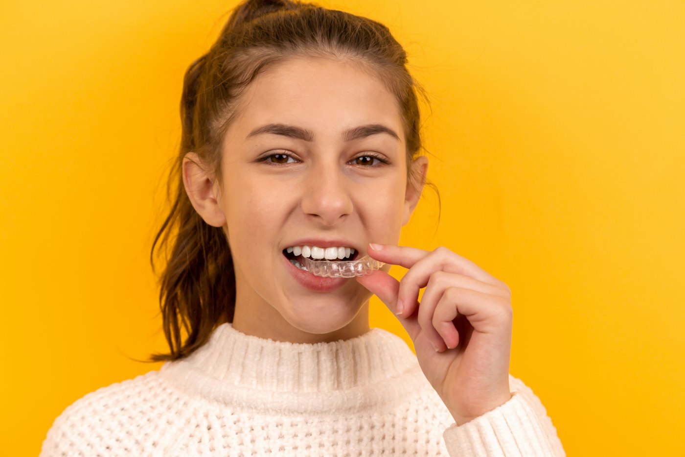 Teenager fitting a clear aligner