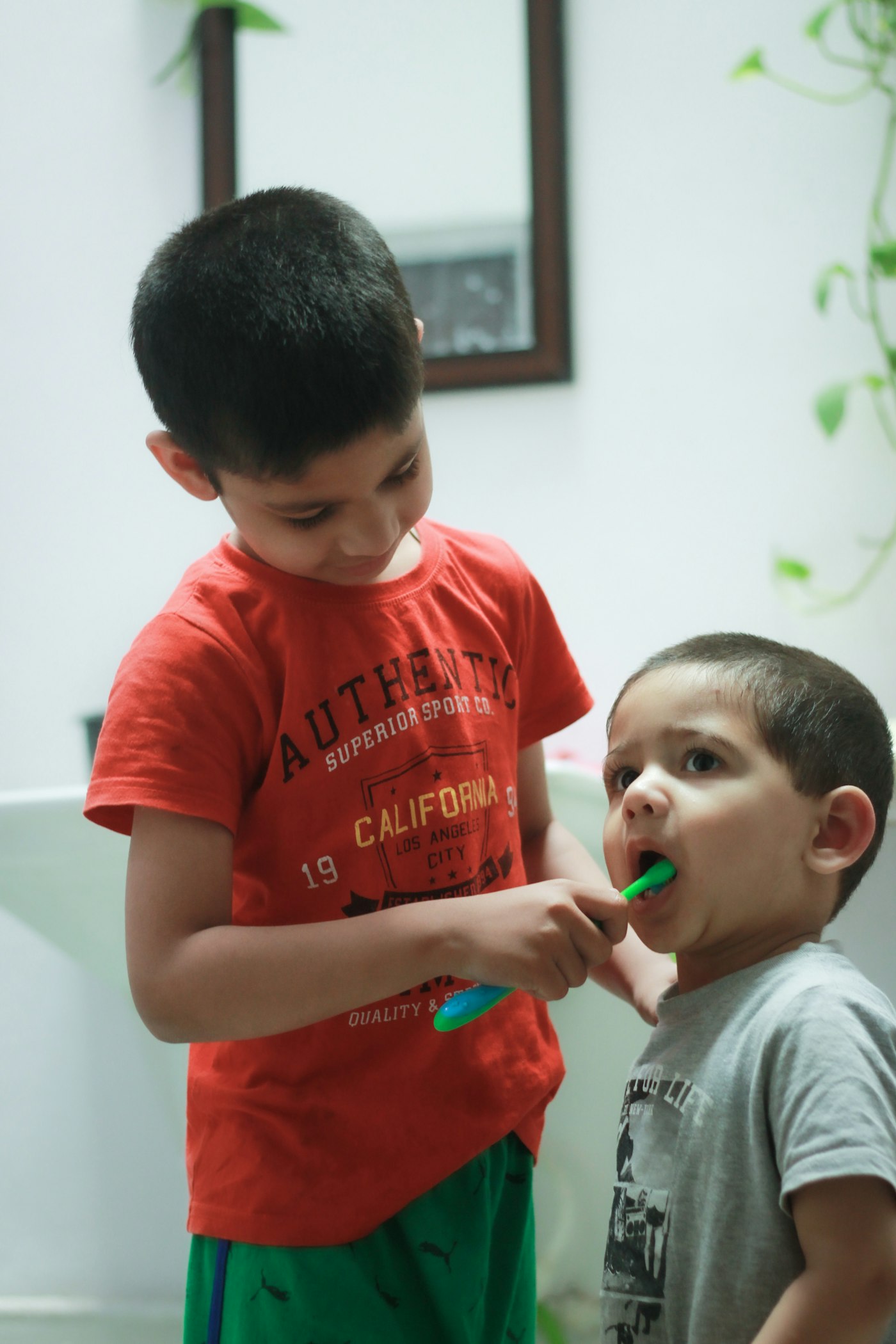 Two boys brushing their teeth